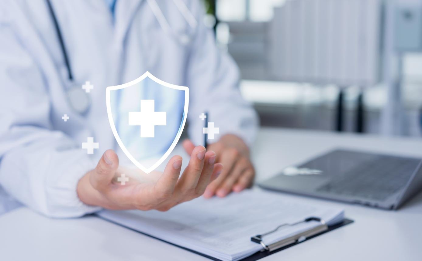 A doctor consulting a patient in the U.S. with short-term health insurance documents